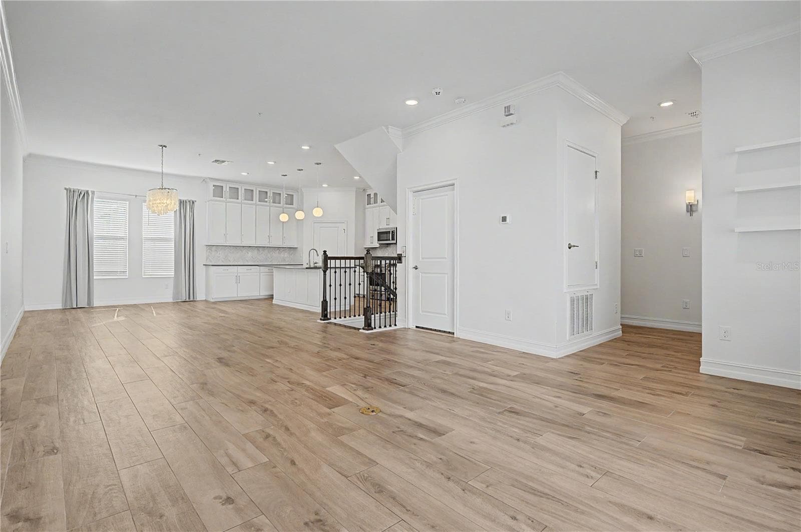 Second-level view from the living area, highlighting the open-concept layout. - 5351 BRIDGE ST #38, TAMPA