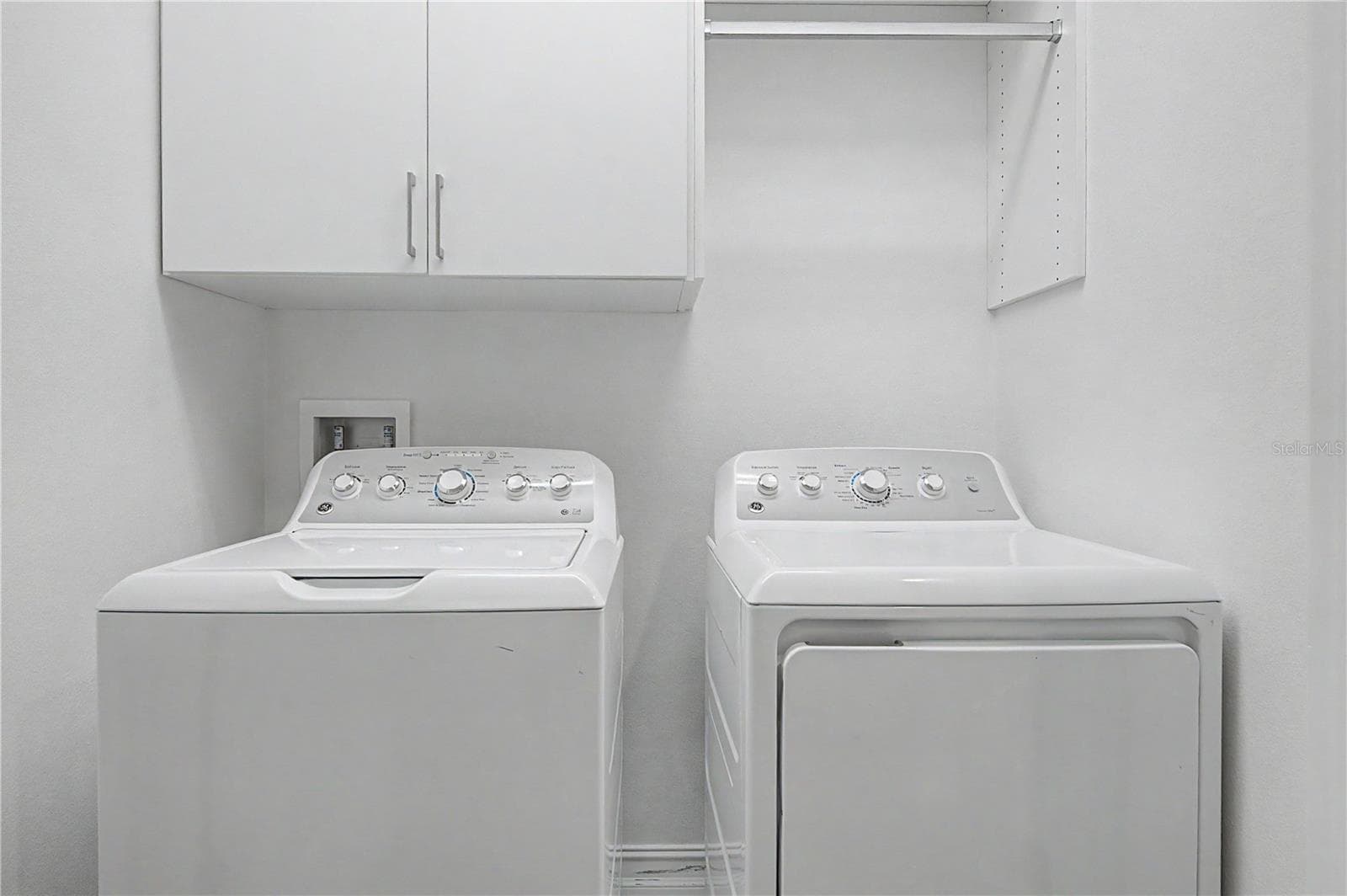 Third-level laundry room featuring high-efficiency washer and dryer connections with ample storage space. - 5351 BRIDGE ST #38, TAMPA