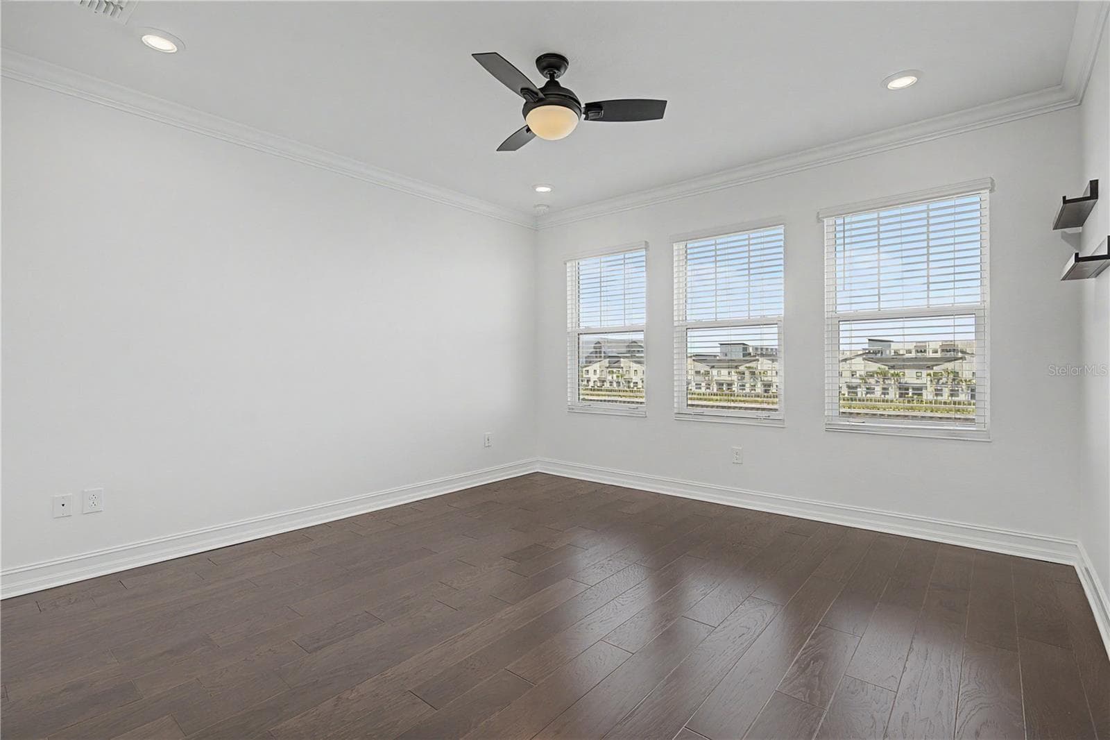 hird-level primary bedroom featuring a trio of west-facing windows that fill the space with natural light. - 5351 BRIDGE ST #38, TAMPA