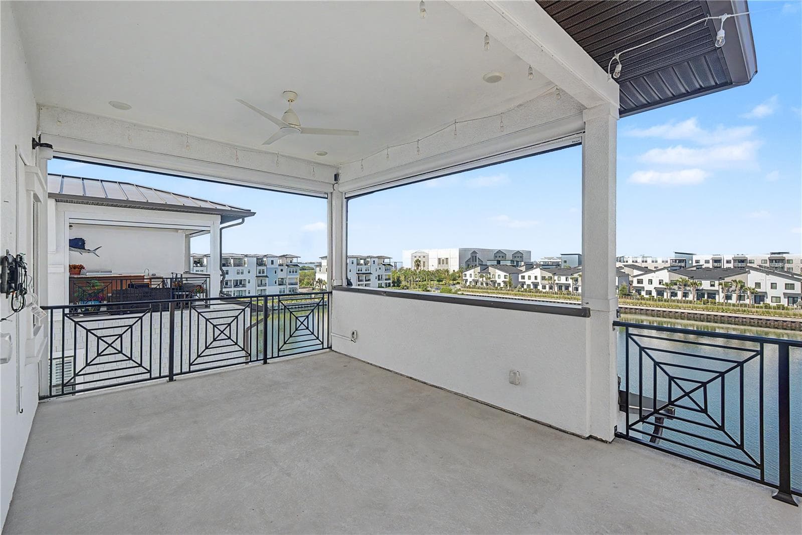 Fourth-level private patio with an inviting outdoor seating area and expansive, seemingly endless water views. - 5351 BRIDGE ST #38, TAMPA