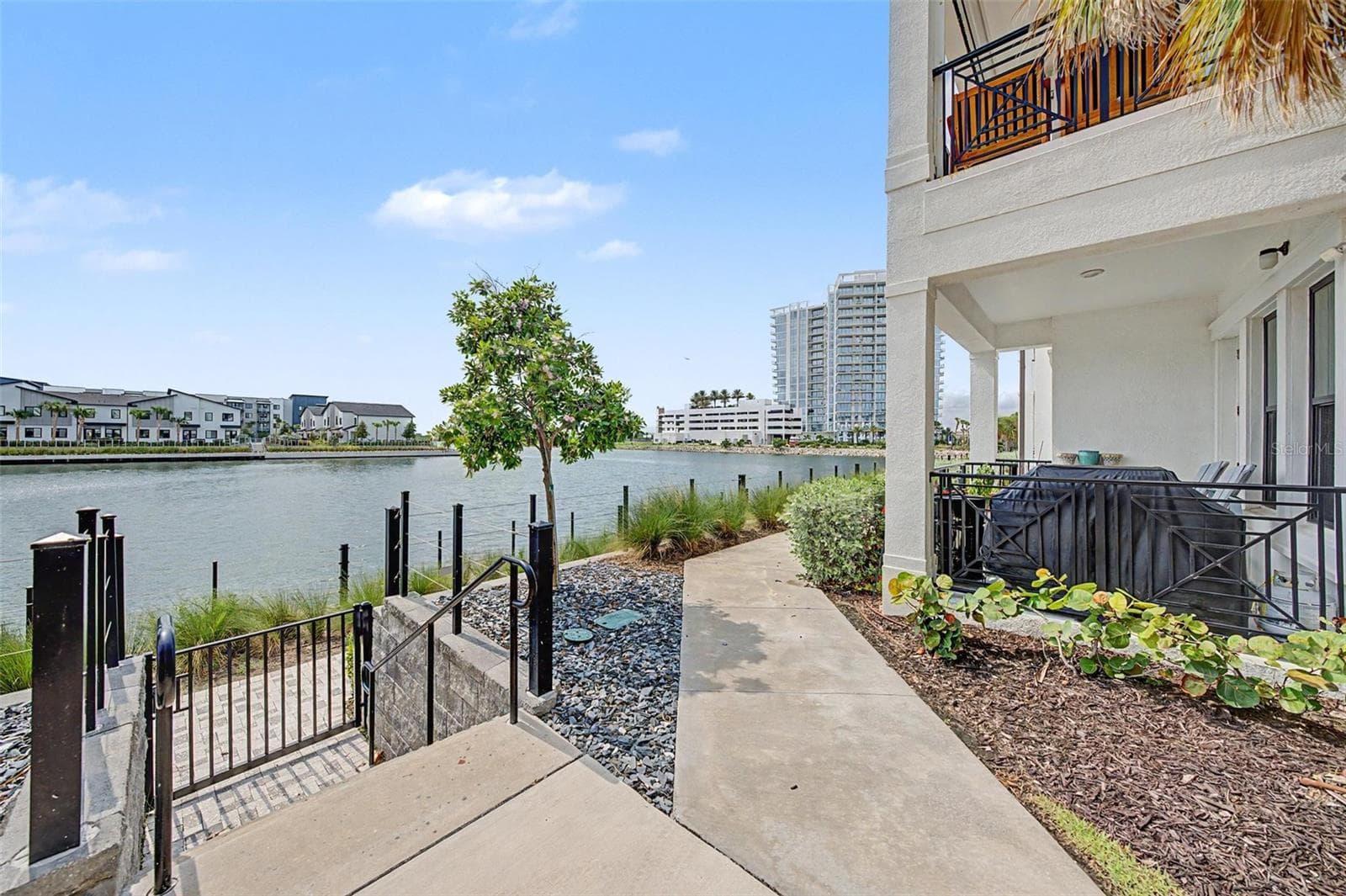 Gated entry to a paved waterfront walkway, perfect for a scenic stroll along the water. - 5351 BRIDGE ST #38, TAMPA