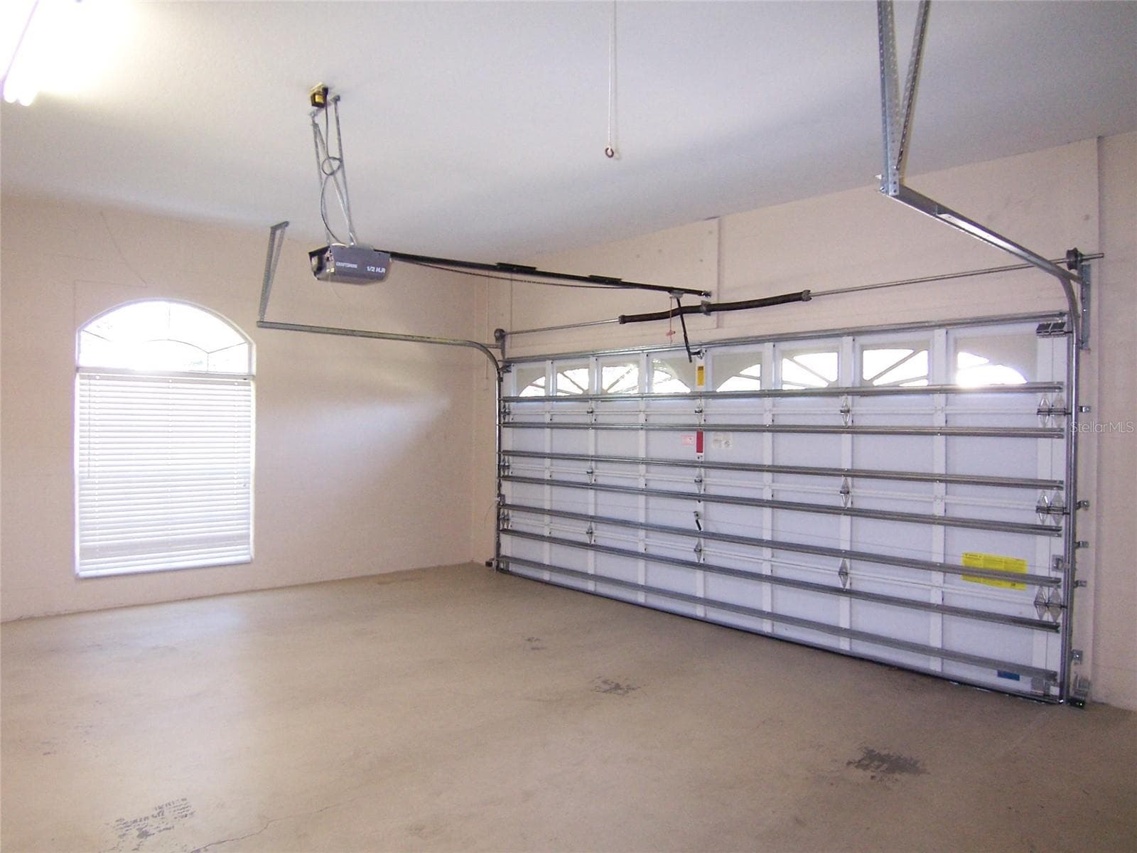 OVERSIZED GARAGE with pull down attic stairs with decked storage above - 5435 SUMMERLAND HILLS DR, LAKELAND