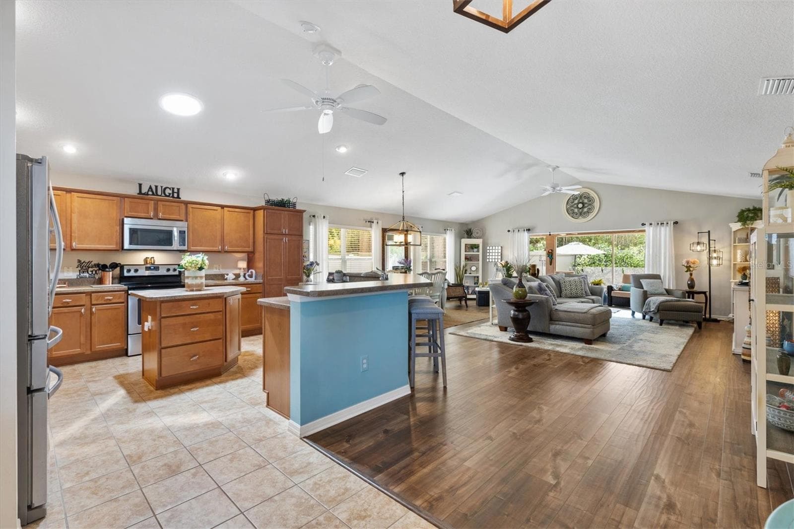 Large great room area with kitchen, dining room and living room. - 2334 ROSE ARBOR ST, THE VILLAGES