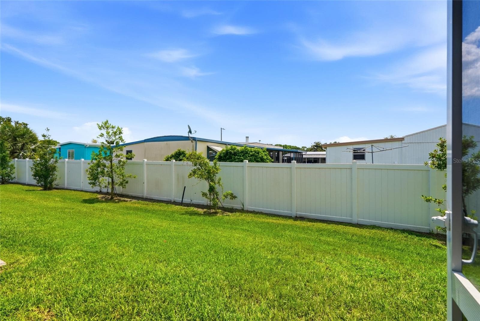 Patio exits to nice green lush grass area - 5282 NEIL DR, ST PETERSBURG