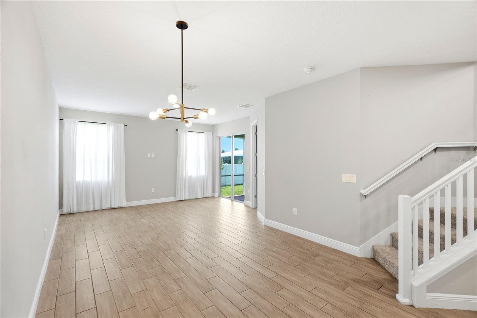 Dining and living area with stairway to second floor - 5282 NEIL DR, ST PETERSBURG