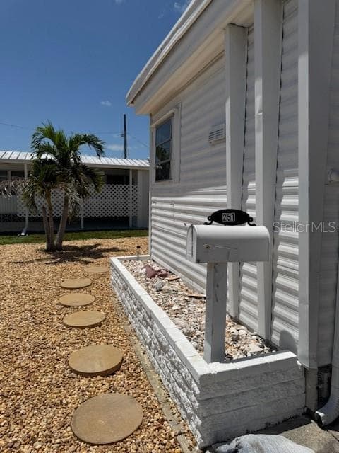 Front of Mobile Home with stepping stones and nice landscaping - 251 SOUTHWINDS DR, SARASOTA