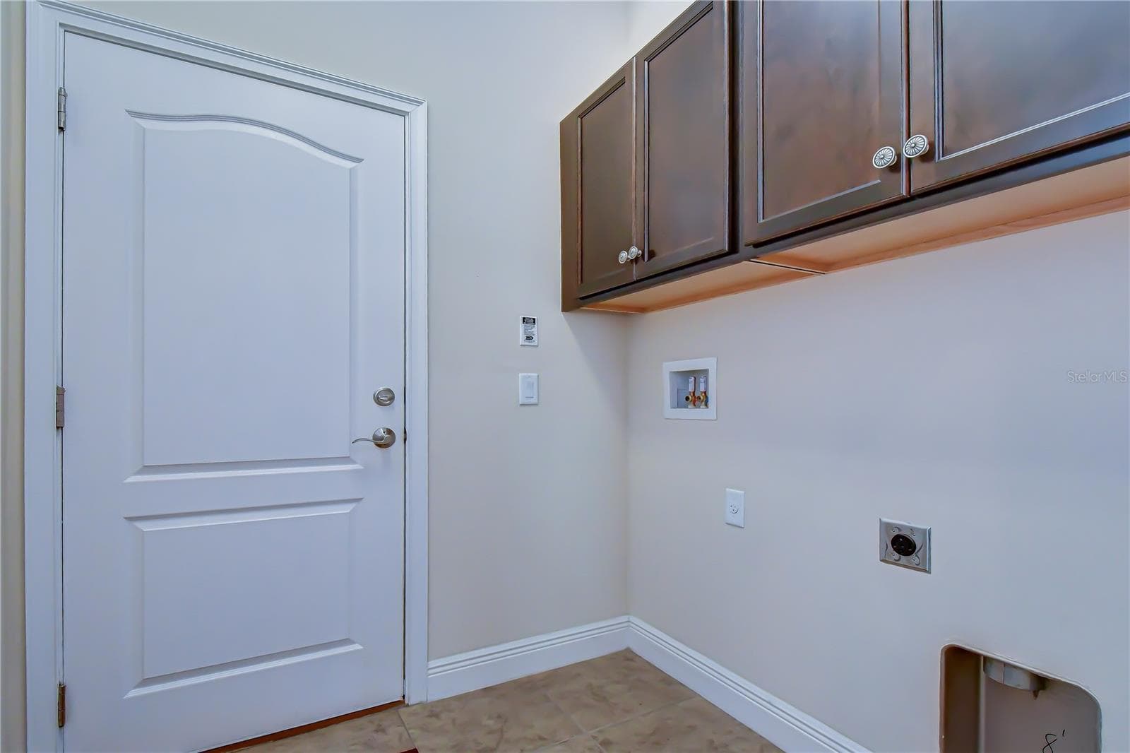 Dedicated laundry room with built-in upper cabinets and hookups. - 826 VINO VERDE CIR, BRANDON