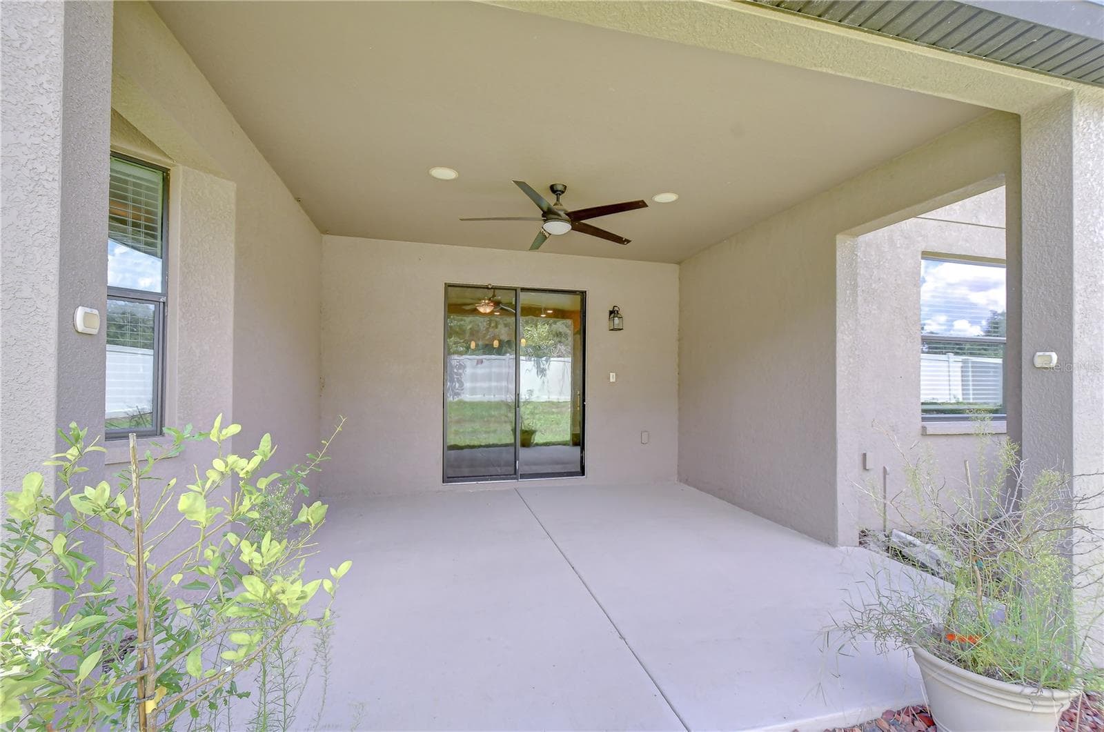Covered outdoor patio ideal for relaxation and entertaining. - 826 VINO VERDE CIR, BRANDON