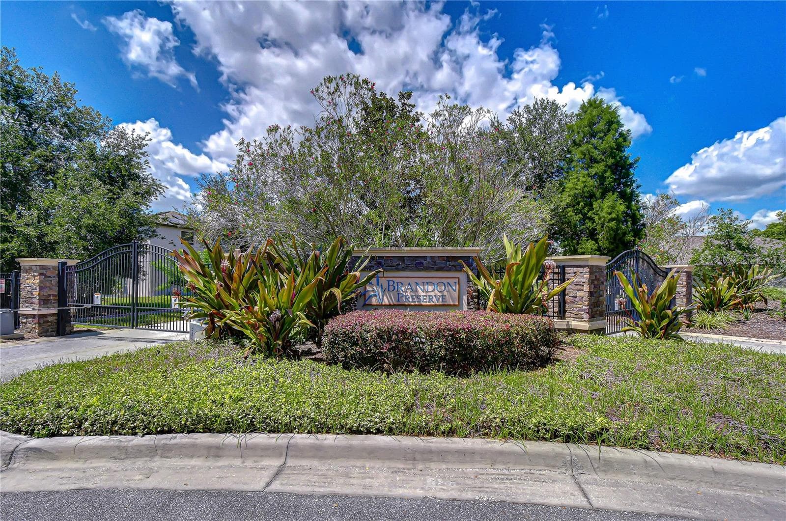 Secure gated entrance welcoming you into the beautifully landscaped community. - 826 VINO VERDE CIR, BRANDON