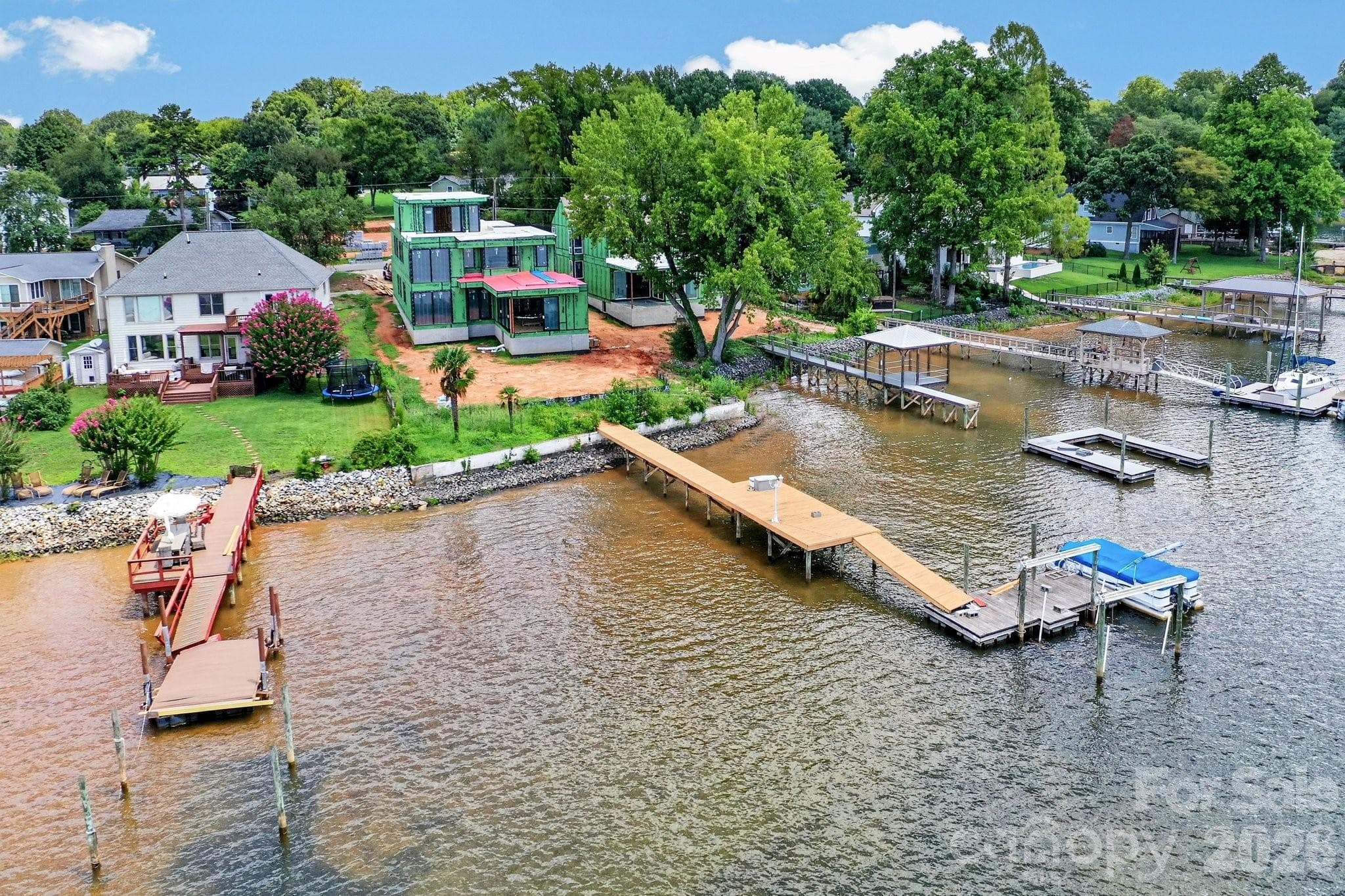 Aerial view of the back of the home with a dock and pier. - Cornelius