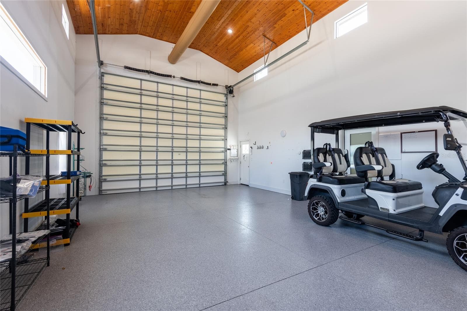 The RV garage showing the automatic RV garage door and the front entrance door on right. - 6757 AMANDA VISTA CIR, LAND O LAKES