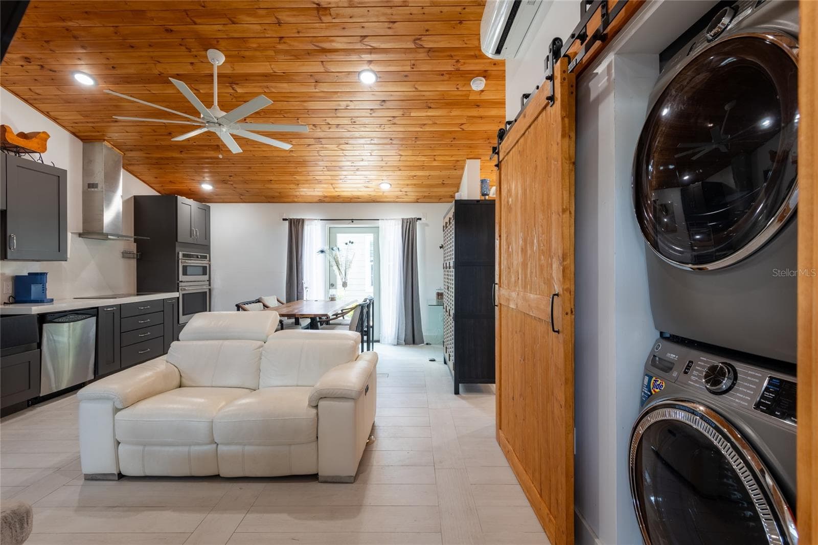 Inside the Carriage house - all existing furnishings stay. Barn doors on right conceal the washer/dryer. - 6757 AMANDA VISTA CIR, LAND O LAKES