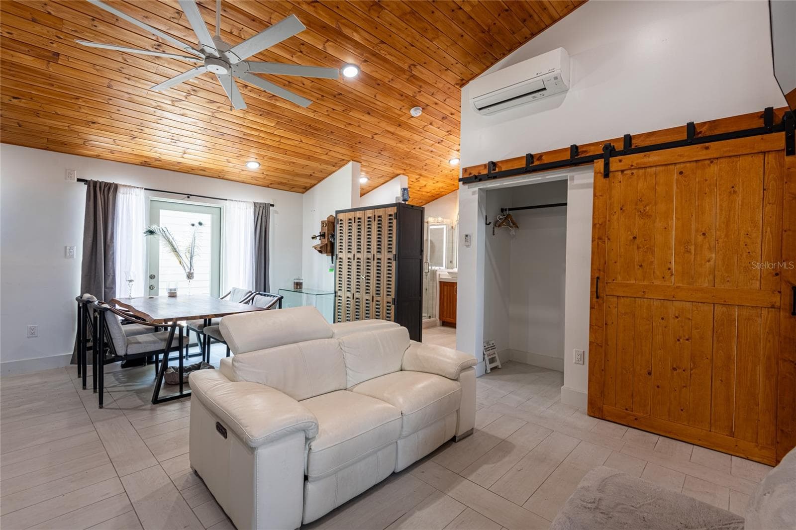 Picture showing the barn doors closed concealing the washer and dryer and opening a storage and/or closet. - 6757 AMANDA VISTA CIR, LAND O LAKES