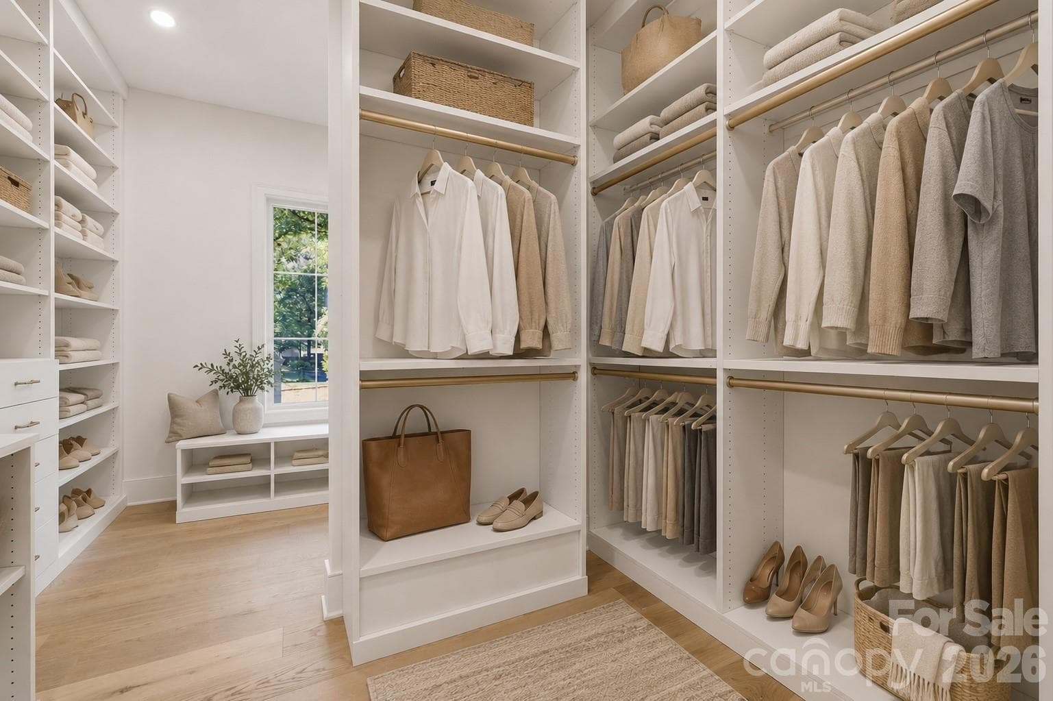 Custom primary closet system with extensive built-in storage and space for optional stackable laundry. - 125 Randstone Court, Charlotte