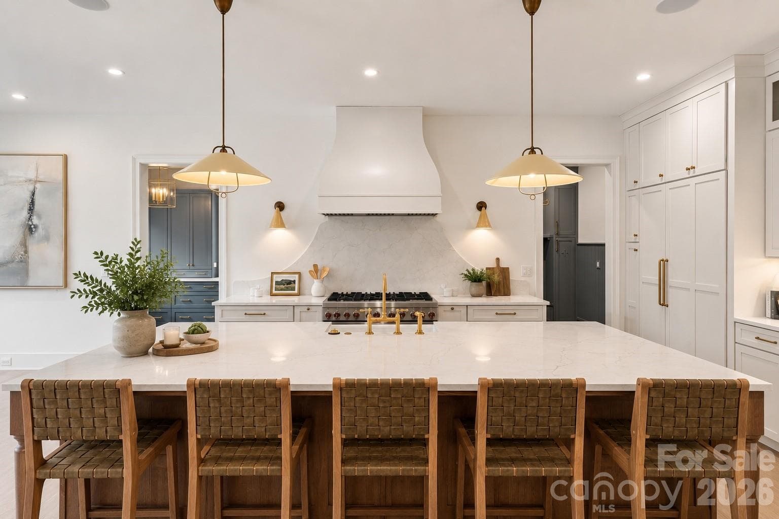 Custom kitchen with oversized island, statement lighting and seamless access to the scullery and pantry - 125 Randstone Court, Charlotte