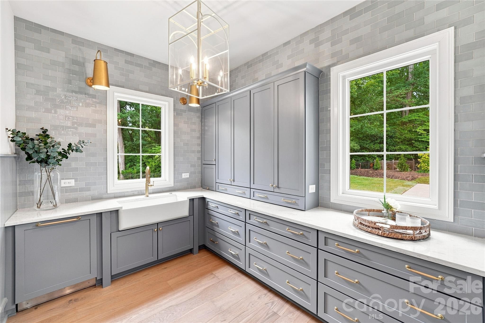 Fully equipped scullery with custom cabinetry, prep sink, second dishwasher and tile extended to the ceiling - 125 Randstone Court, Charlotte