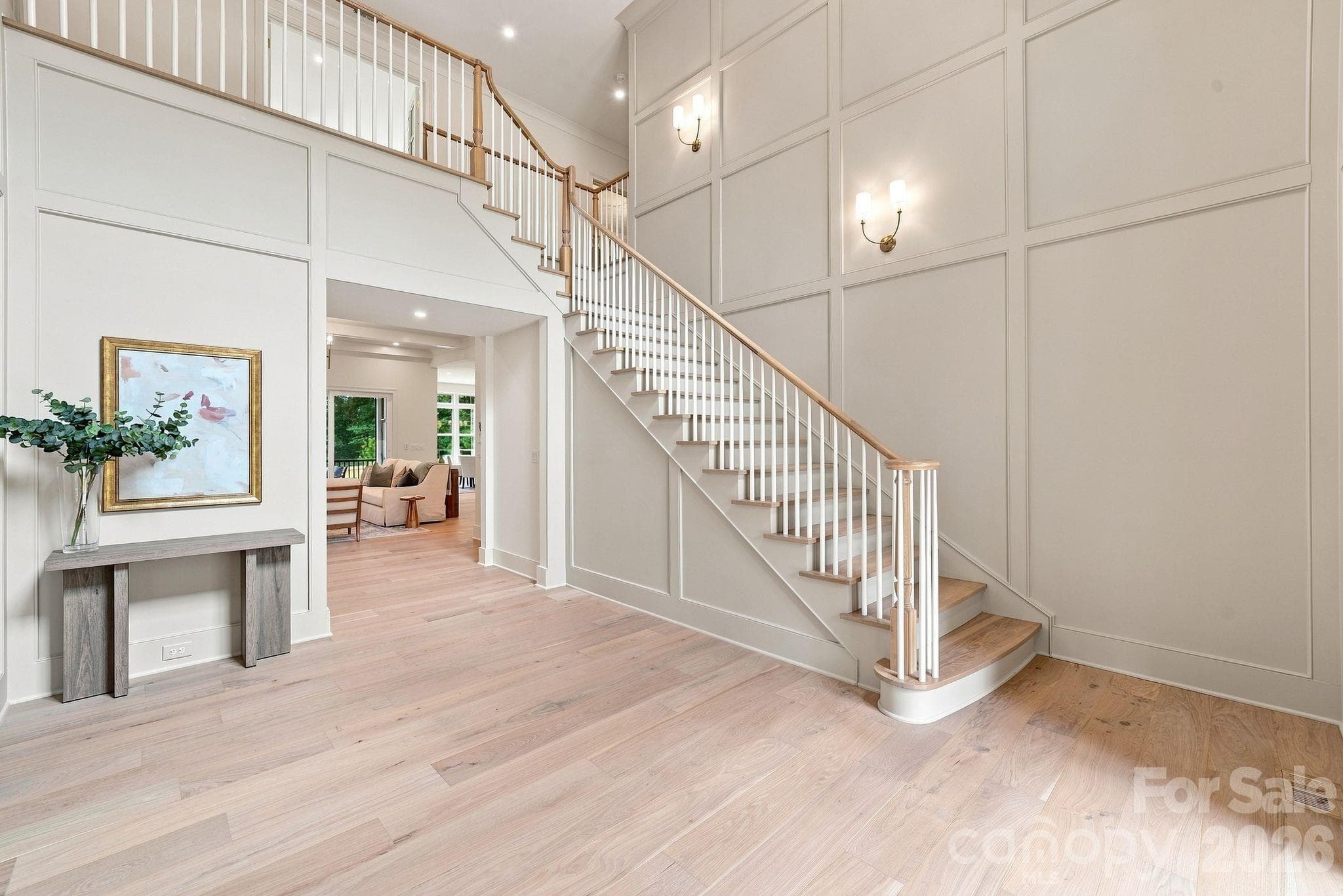 Dramatic two-story foyer with custom panel molding and statement staircase. - 125 Randstone Court, Charlotte