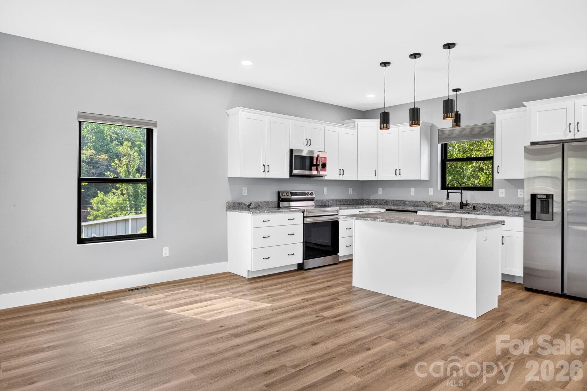 Bright, open floor plan maximizes natural light and passive solar efficiency throughout the sustainably designed home. - 613 Salem Heights Lane, Swannanoa