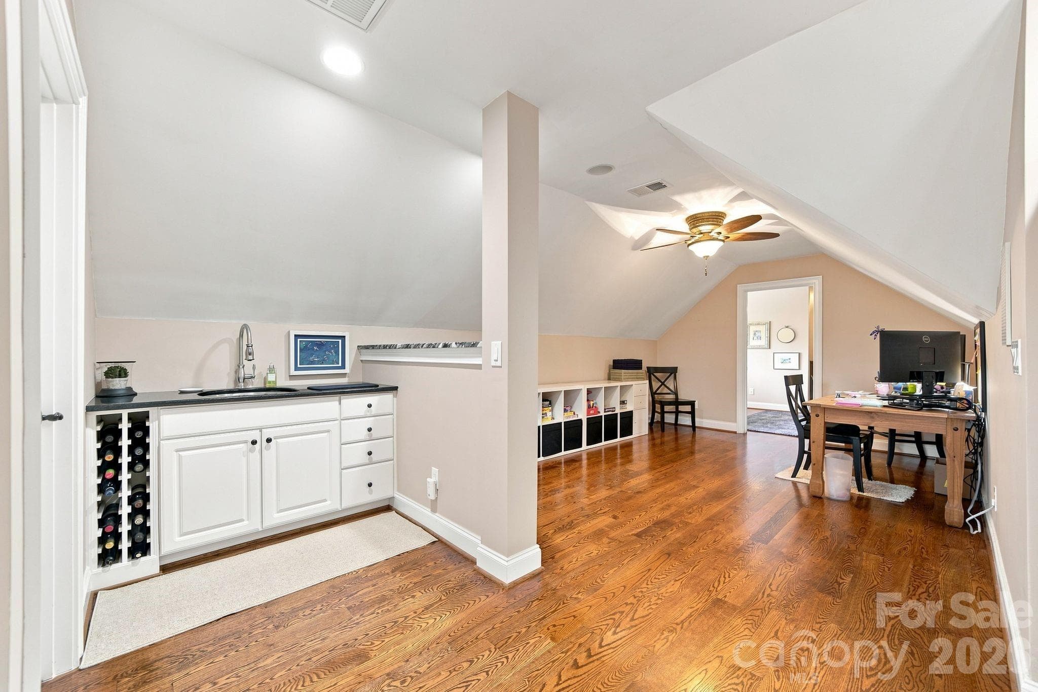 The wet bar and hardwood floors make this area suitable for multiple uses. - 1001 Heritage Acres Drive, Weddington