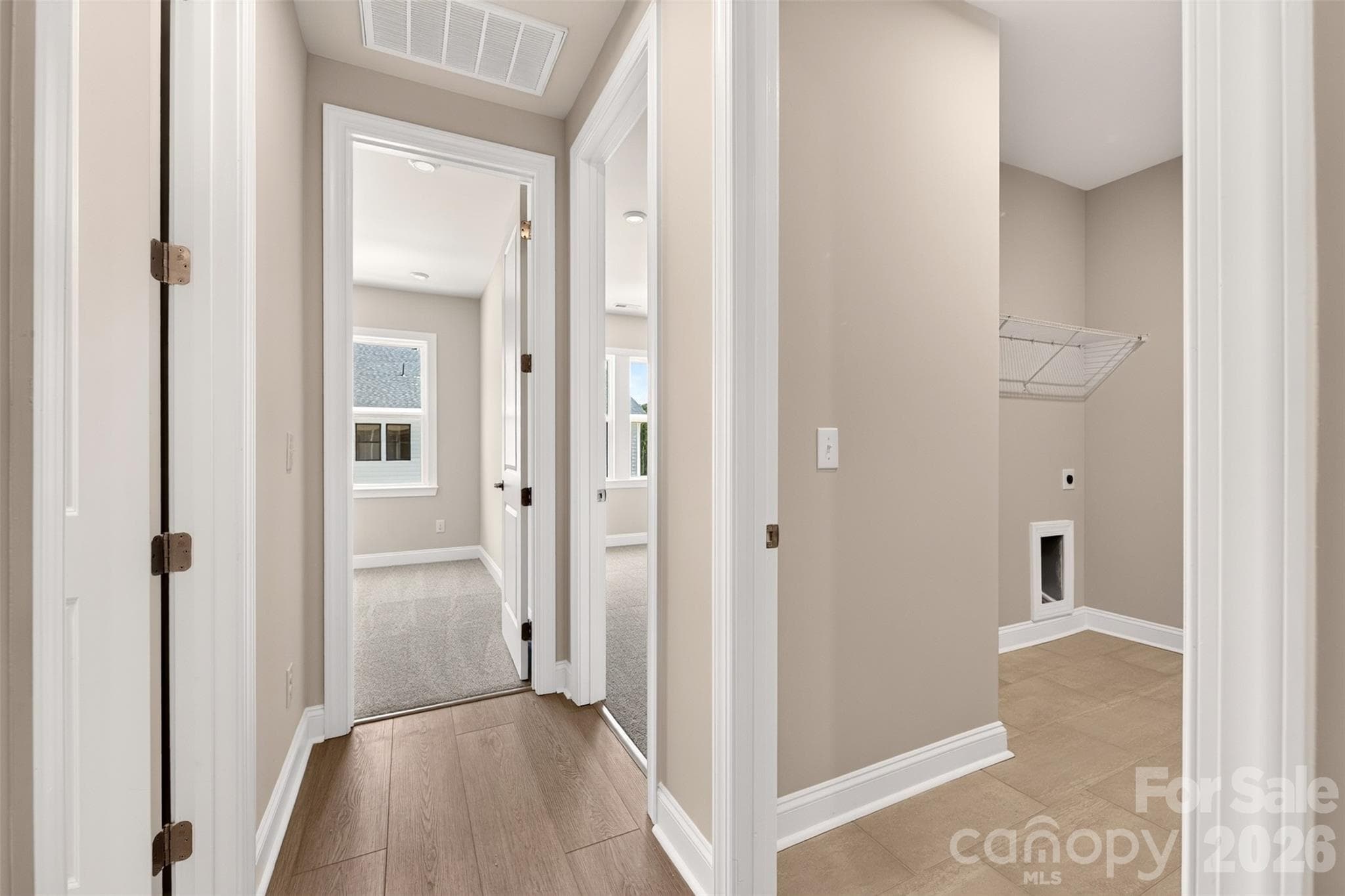 Third floor hallway with the laundry room - 6008 Yellow Buckeye Drive, Charlotte