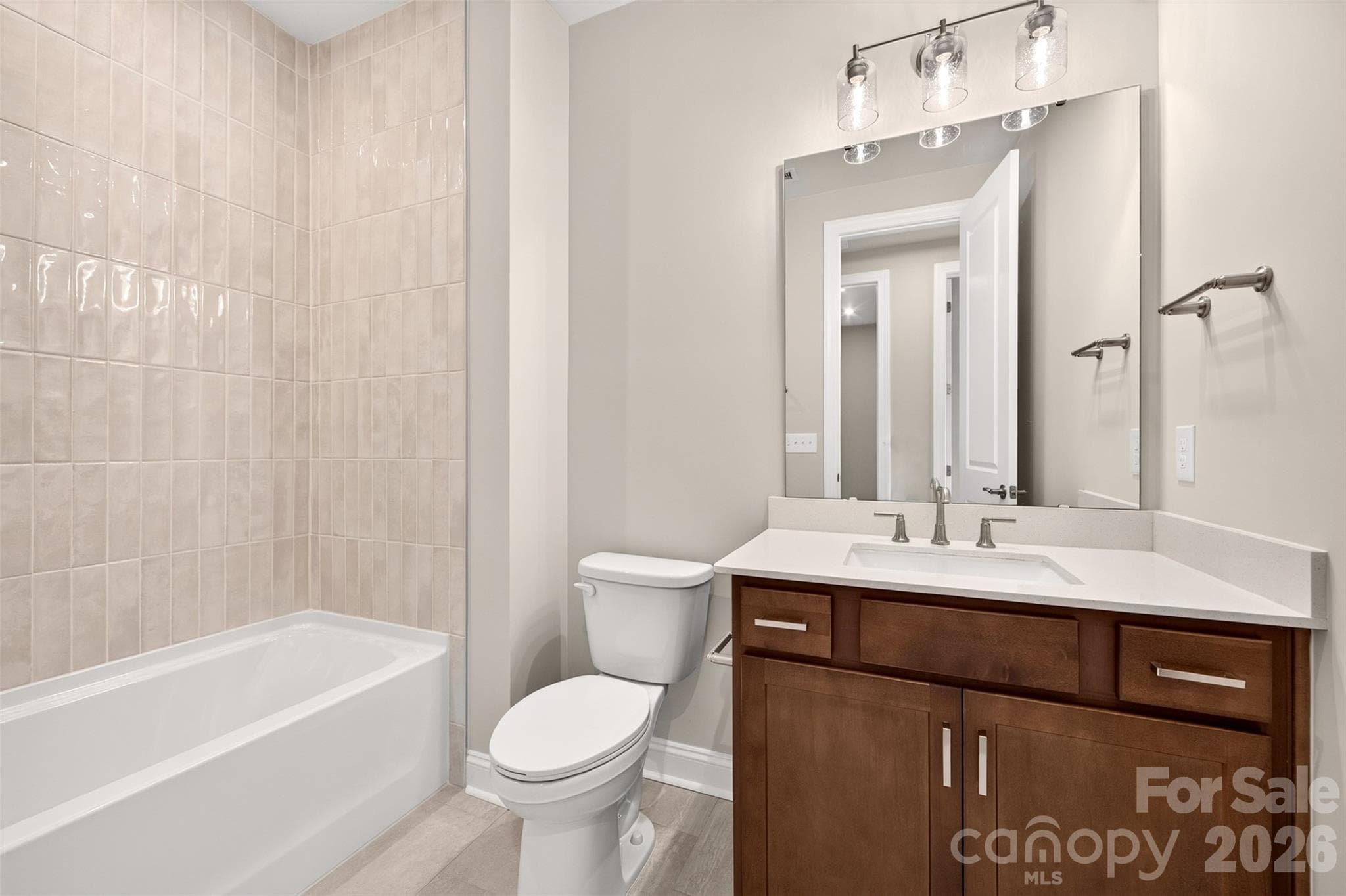 Secondary bathroom with tiled walls above the tub - 6008 Yellow Buckeye Drive, Charlotte