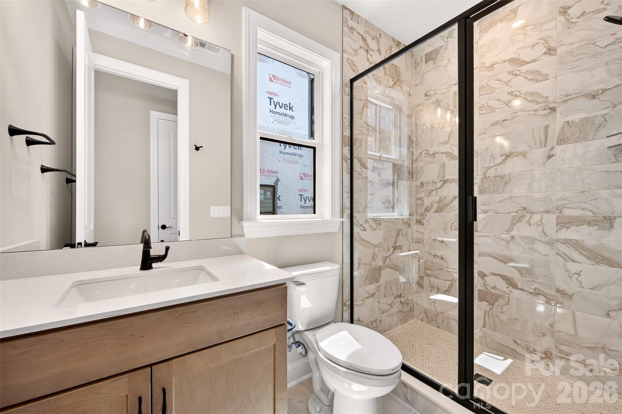 First floor GenSmart Suite full bathroom with walk-in shower - 6012 Yellow Buckeye Drive, Charlotte