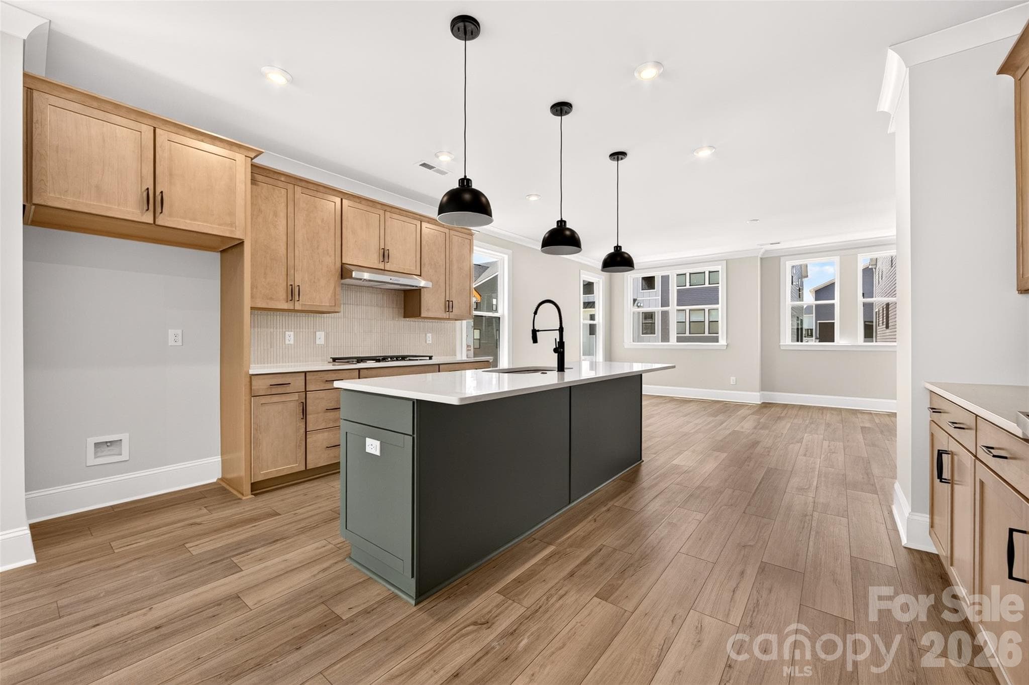 Light filled gourmet kitchen with dual toned cabinets - 6012 Yellow Buckeye Drive, Charlotte