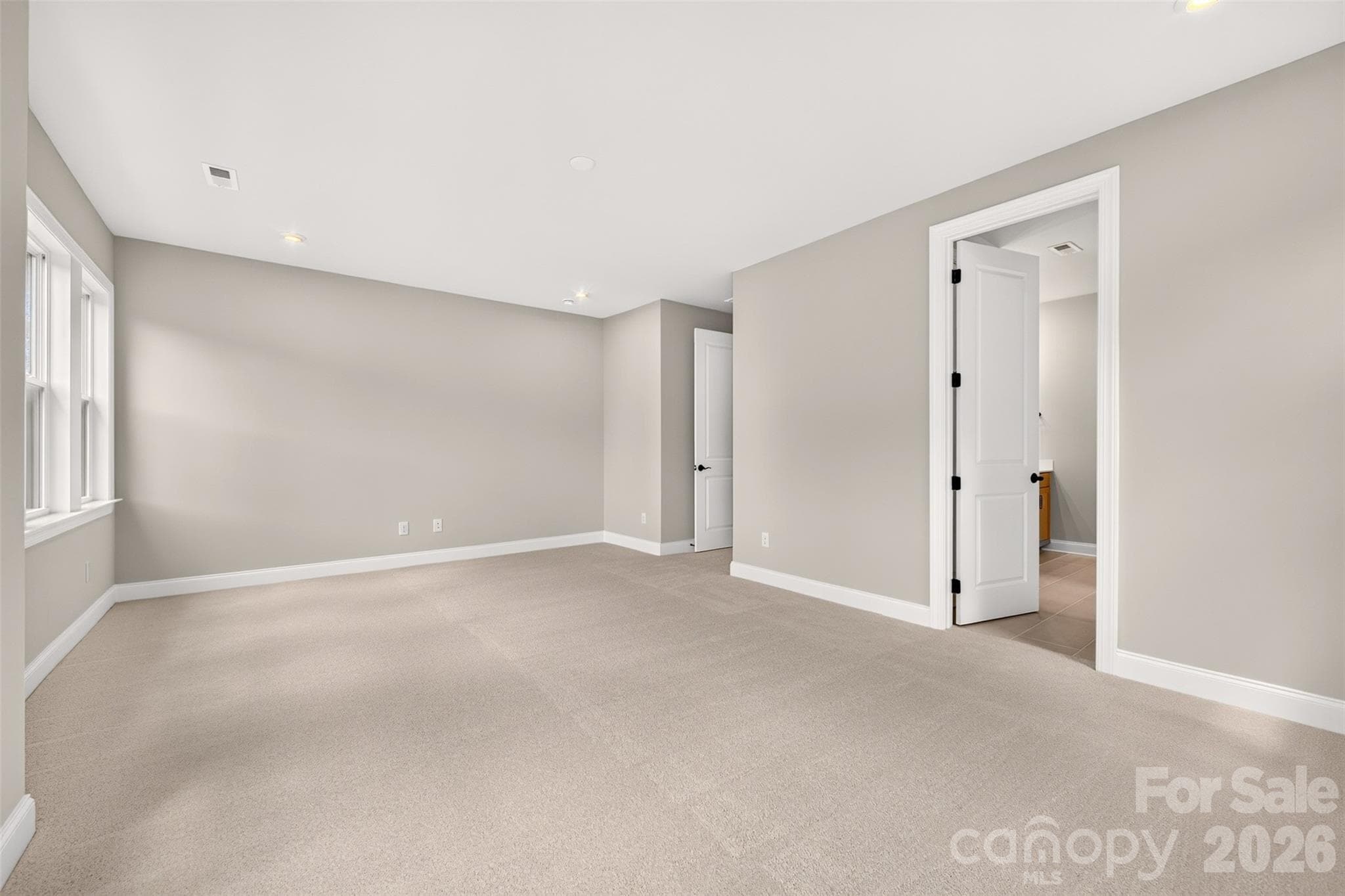 light filled primary bedroom - 6012 Yellow Buckeye Drive, Charlotte
