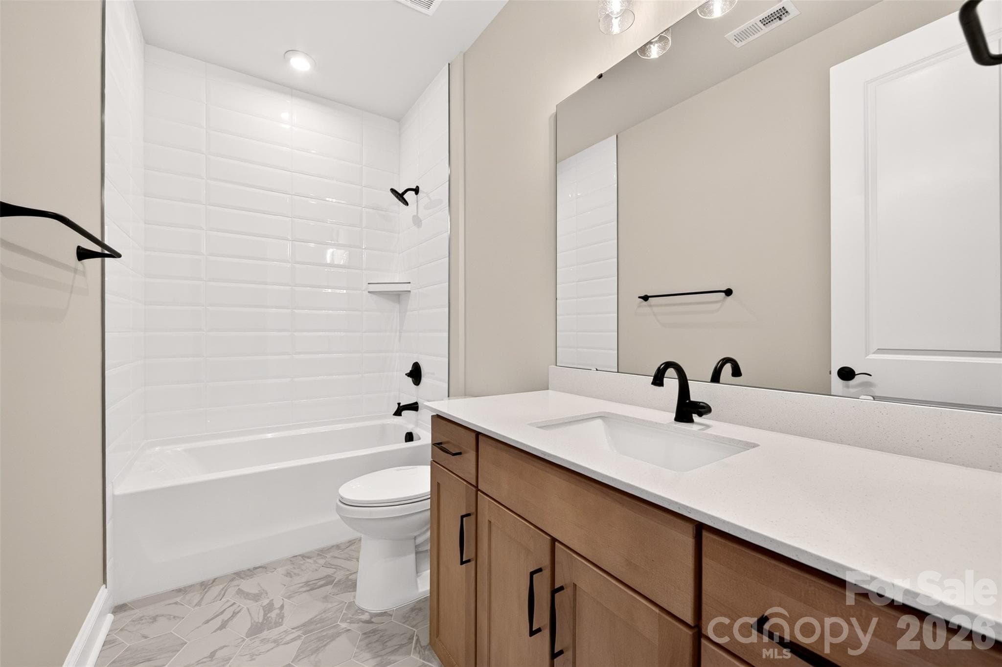 Secondary bathroom with tiled walls above the tub - 6012 Yellow Buckeye Drive, Charlotte