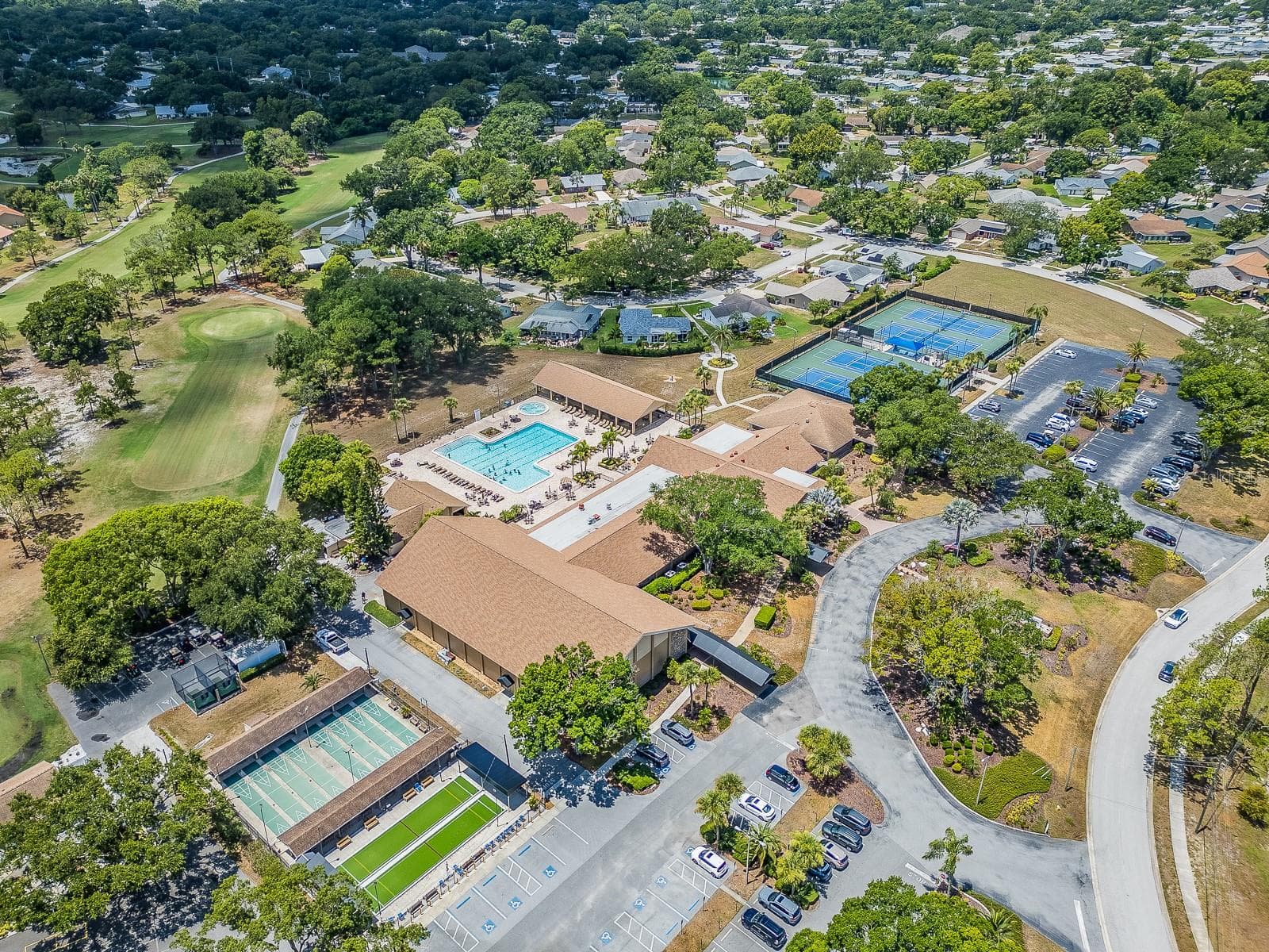 Arial view of Highland Lakes clubhouse and recreation complex, featuring community pool, courts, and other amenities! - 1207 TIMBERBROOKE DR, PALM HARBOR