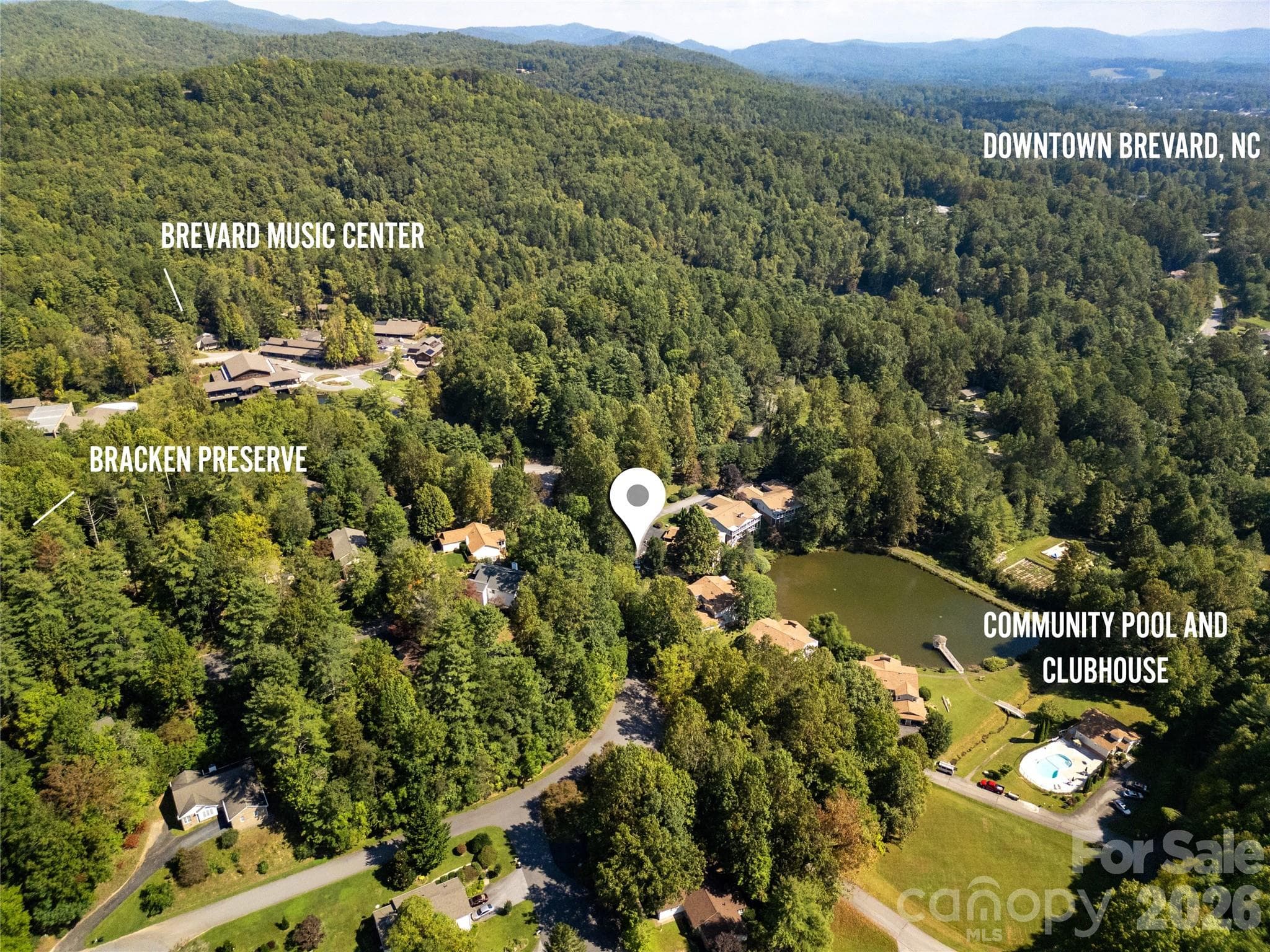 A bird’s-eye view showcasing the condo’s prime location in Waterford Place, with key landmarks labeled for perspective. The image highlights the proximity to Bracken Preserve, ideal for hiking and outdoor adventure; the Brevard Music Center, home to world-class summer performances; the Community Pool and Clubhouse:  and Downtown Brevard, offering dining, shopping, and cultural experiences, all within easy reach of the condo. - Brevard