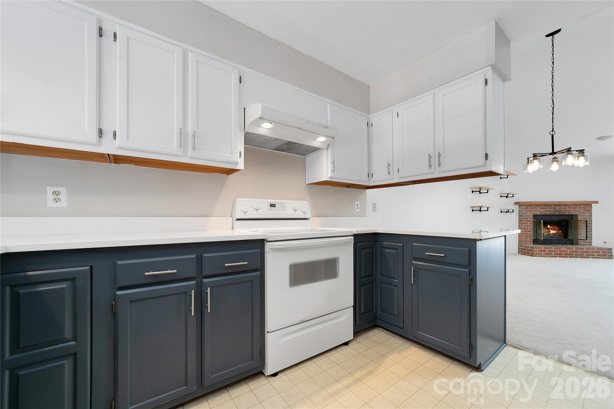 Entry to the kitchen is just inside the condo’s front door, opening directly into an inviting, open-concept layout that flows seamlessly into the living room. - Brevard
