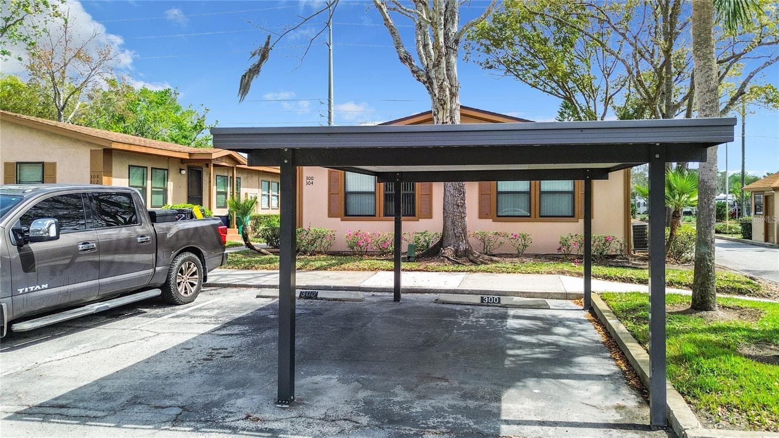 2 Parking spaces with 1 covered right outside of the unit. - 300 ERON WAY #1, WINTER GARDEN