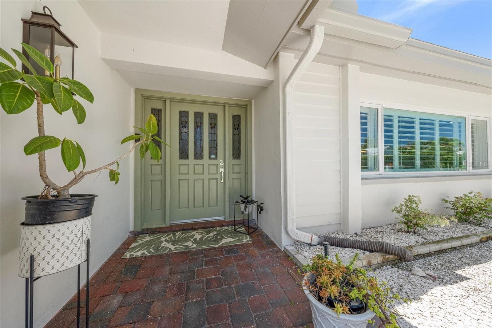 Beautiful entryway! Bahama style shutters on the windows. - 821 JACARANDA DR, LARGO