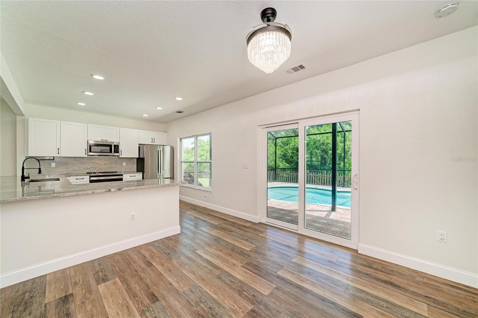 Eat-in dining space with views of pool from the new sliding door. - 3220 37TH TER E, BRADENTON