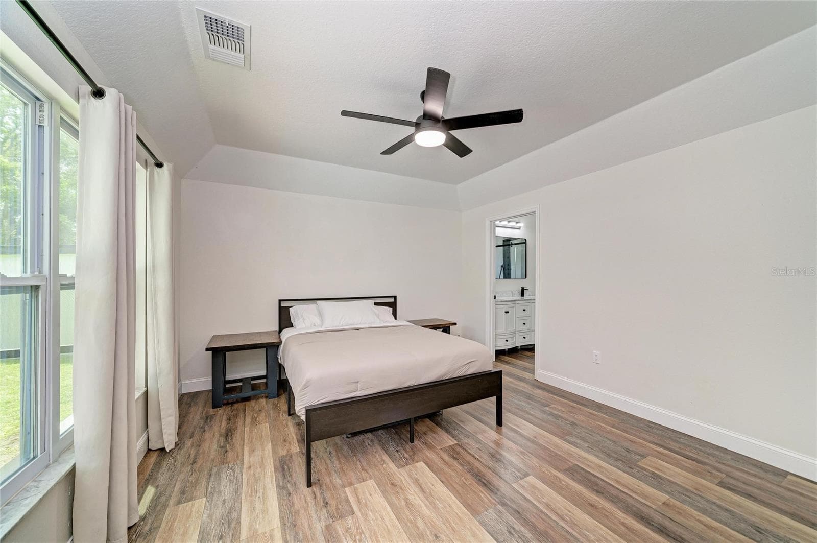 Primary bedroom is on first floor with ensuite bathroom and walk-in closet. - 3220 37TH TER E, BRADENTON