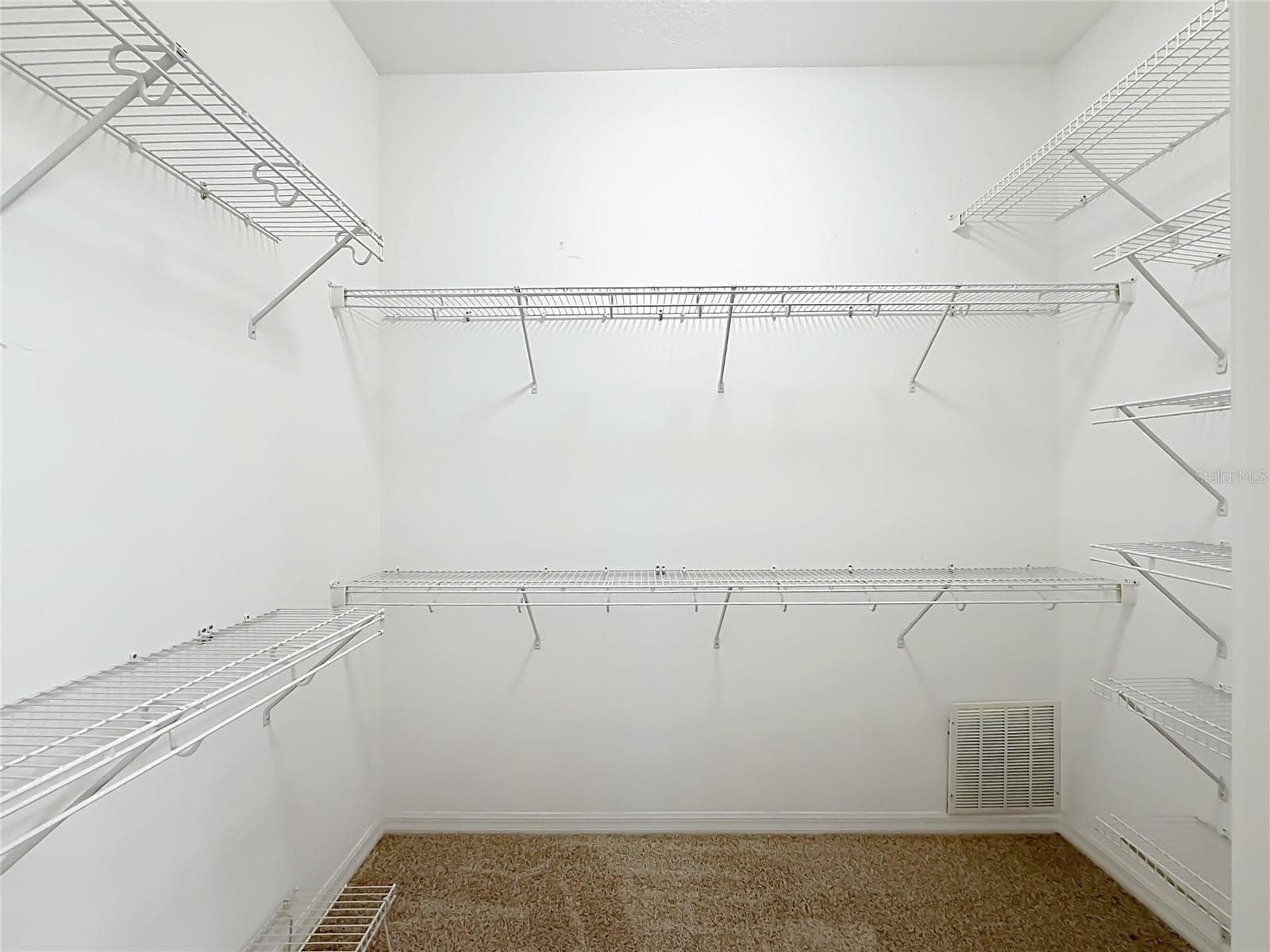 Large Walk in closet with racks and new carpet. - 11932 SE 179TH ST, SUMMERFIELD