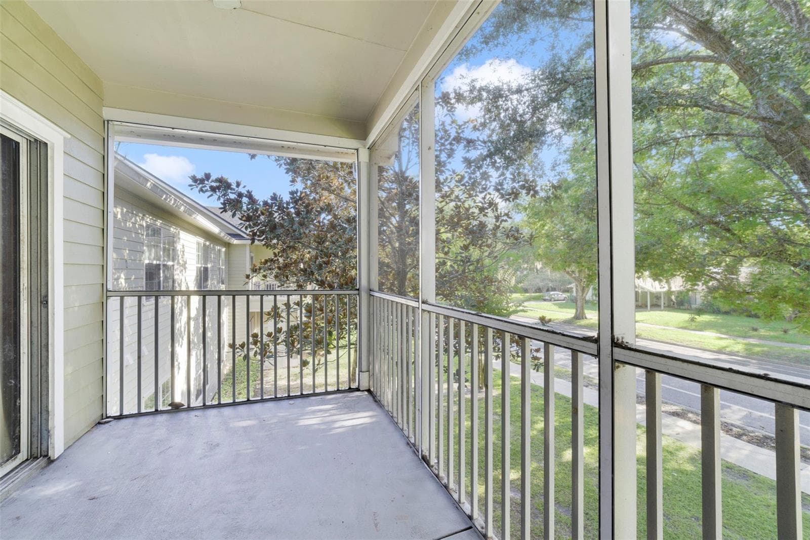 Enjoy relaxing on your screened-in patio with outside storage and a ceiling fan! - 3721 S LAKE ORLANDO PKWY #6, ORLANDO