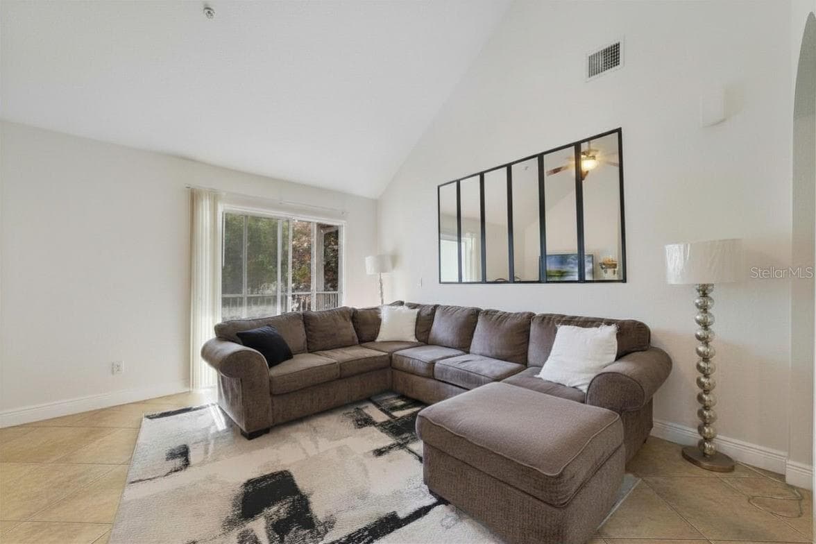 Spacious living room with sliding door patio access - 3721 S LAKE ORLANDO PKWY #8, ORLANDO
