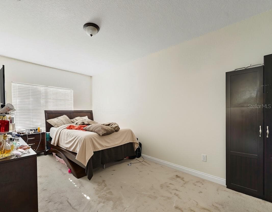 Spacious primary bedroom with en-suite bathroom - 3721 S LAKE ORLANDO PKWY #8, ORLANDO