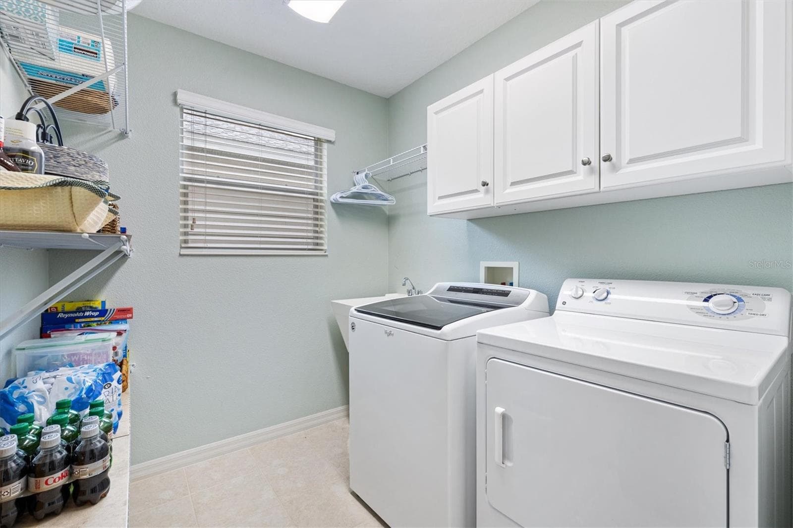 Inside laundry room with cabinets and storage shelves - 2494 FLINTSHIRE AVE, THE VILLAGES