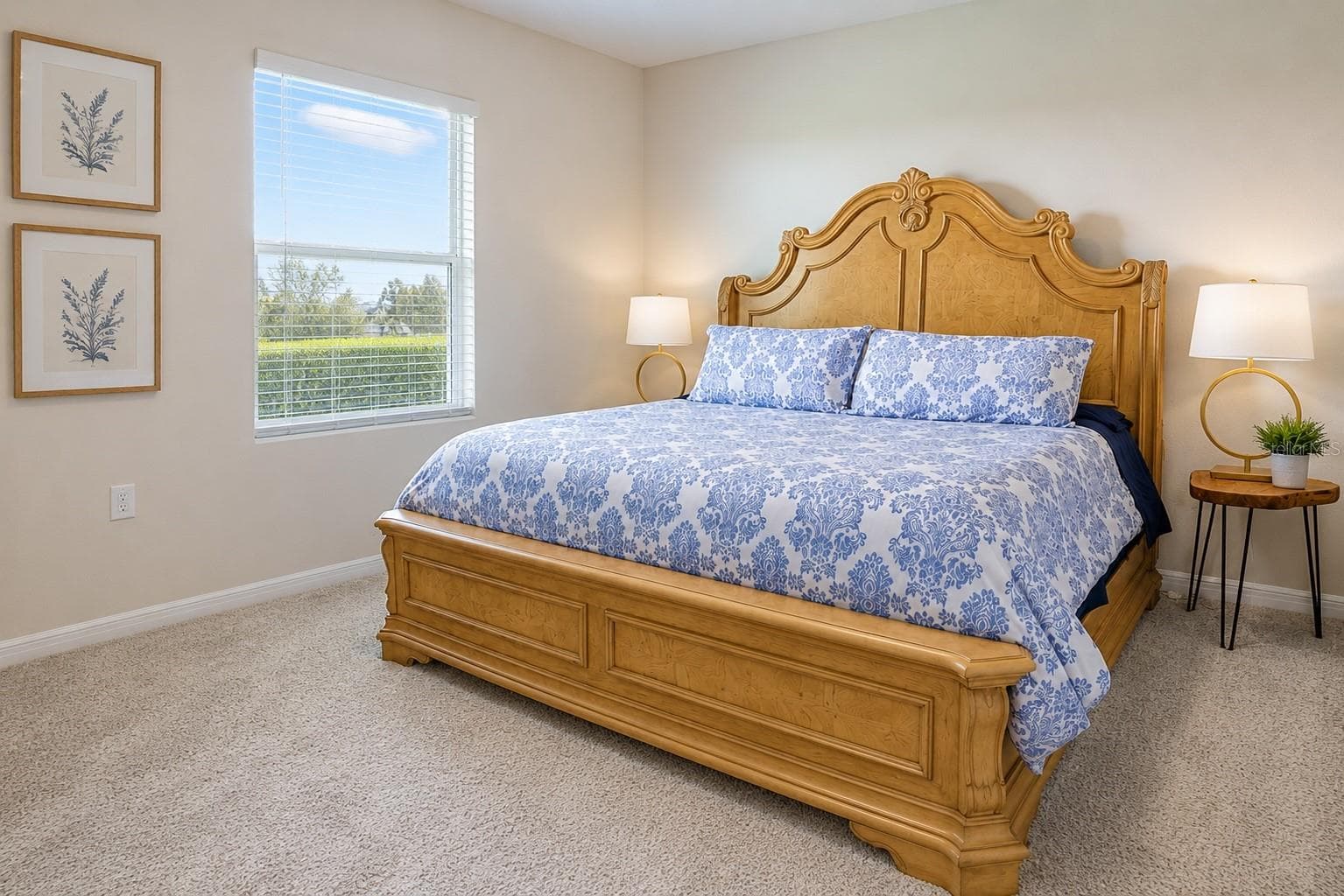 Spacious primary suite with plush carpet, oversized window overlooking green space, and room to spare for a king bed and full furniture set. - 17632 CRESCENT MOON LOOP, BRADENTON