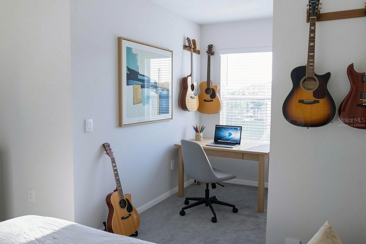 Virtually StagedThird bedroom offers a versatile flex space with carpet flooring and a large window — ideal as a guest room, den, or additional home office. - 17632 CRESCENT MOON LOOP, BRADENTON