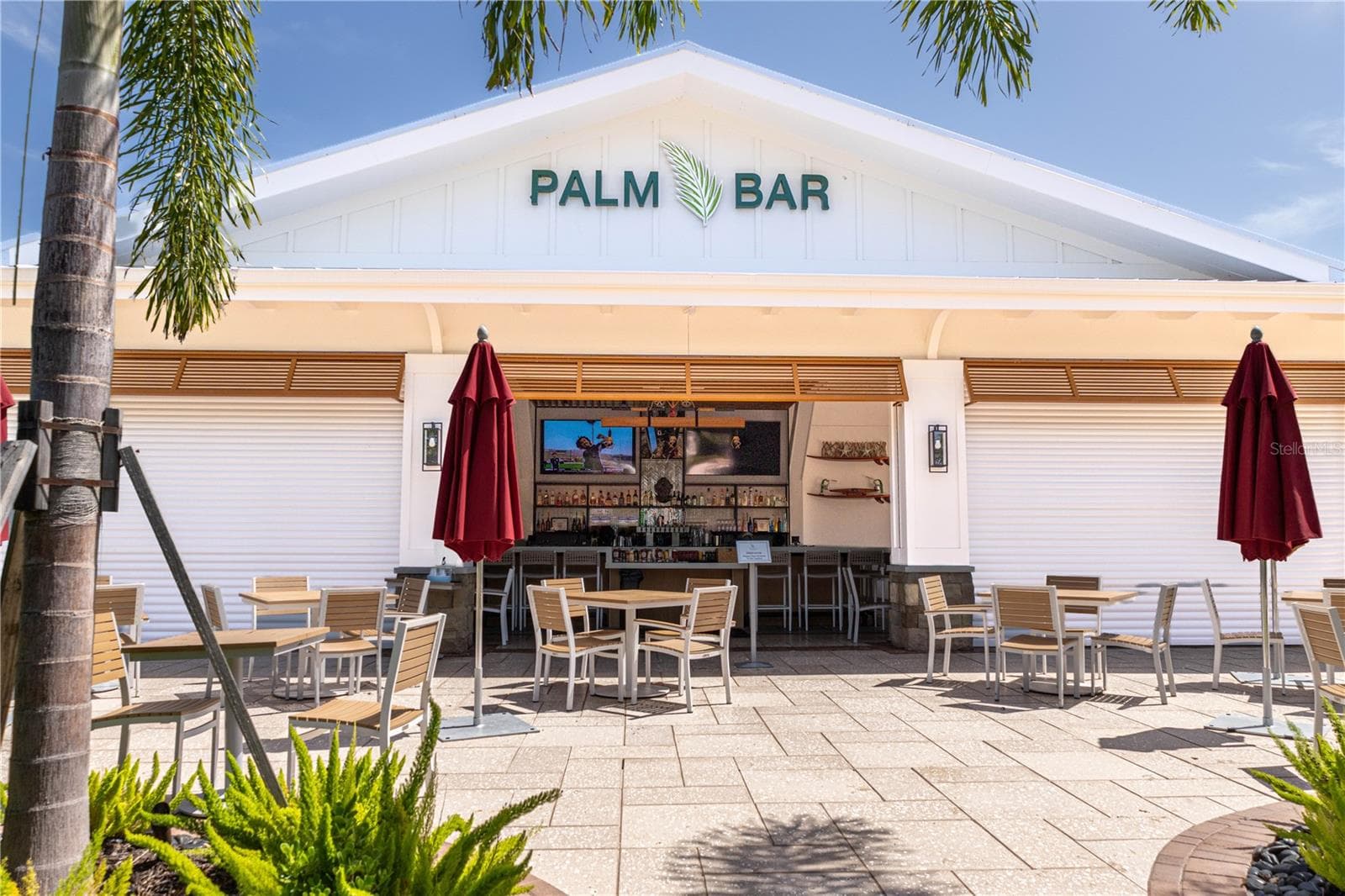 The Palm Bar — the community's poolside restaurant and bar at The Resort Club, Star Farms' signature 27,000-square-foot clubhouse. Grab a drink, catch the game, and soak in the resort lifestyle just steps from the pool. - 17632 CRESCENT MOON LOOP, BRADENTON