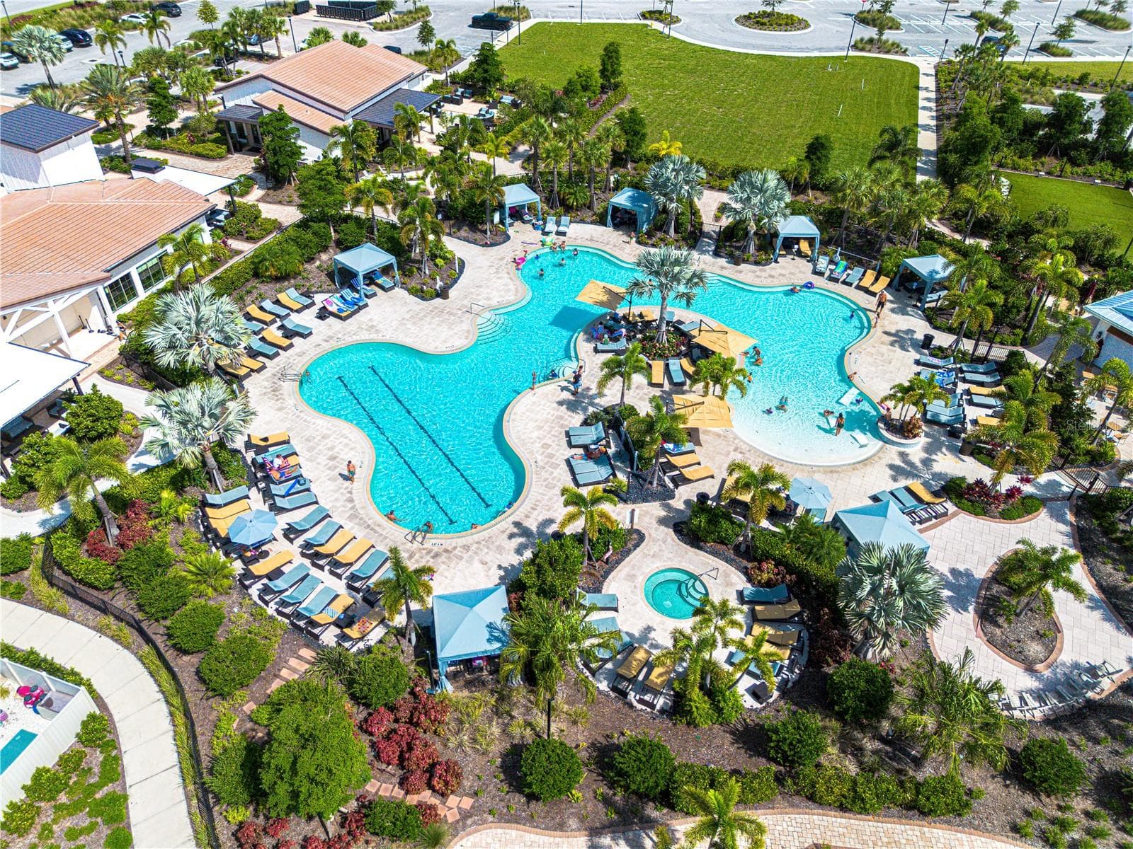 Resort-style pool at The Resort Club — Star Farms' social hub, complete with cabanas, beach-style lounging, and golf cart access from your front door. - 17632 CRESCENT MOON LOOP, BRADENTON