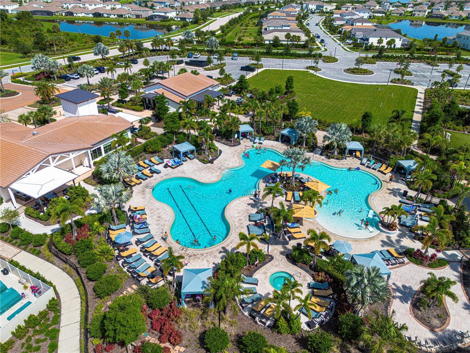Resort-style pool at The Resort Club — Star Farms' social hub, complete with cabanas, beach-style lounging, and golf cart access from your front door. - 17632 CRESCENT MOON LOOP, BRADENTON