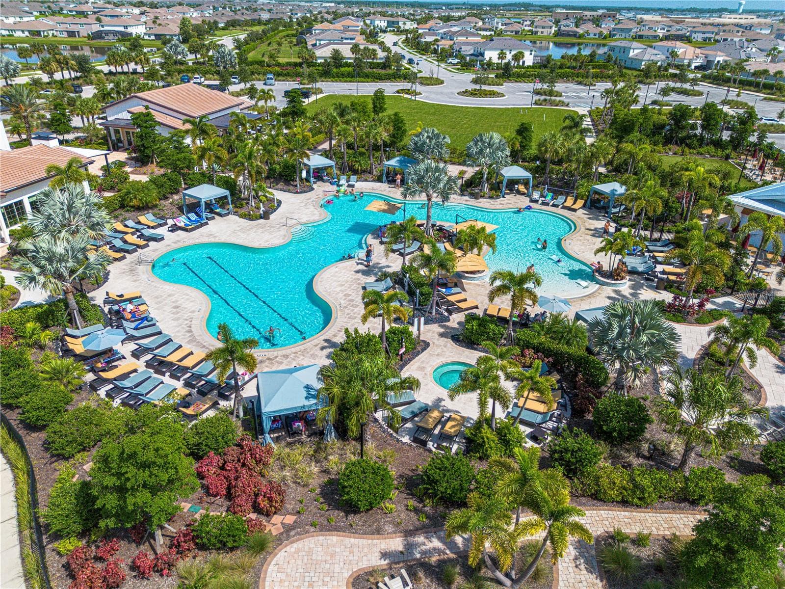 Resort-style pool at The Resort Club — Star Farms' social hub, complete with cabanas, beach-style lounging, and golf cart access from your front door. - 17632 CRESCENT MOON LOOP, BRADENTON