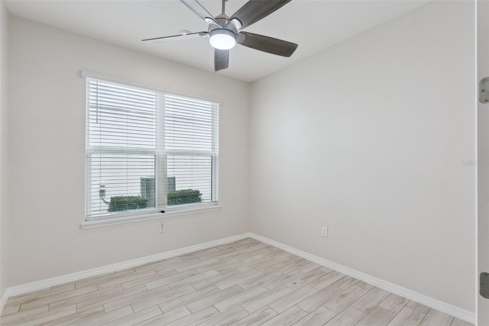 Downstairs Study – Alternate view highlights the study’s convenient location just off the main living area, with easy access to the staircase and an open, light-filled feel. - 1287 VERDANT GLADE PL, WINTER PARK
