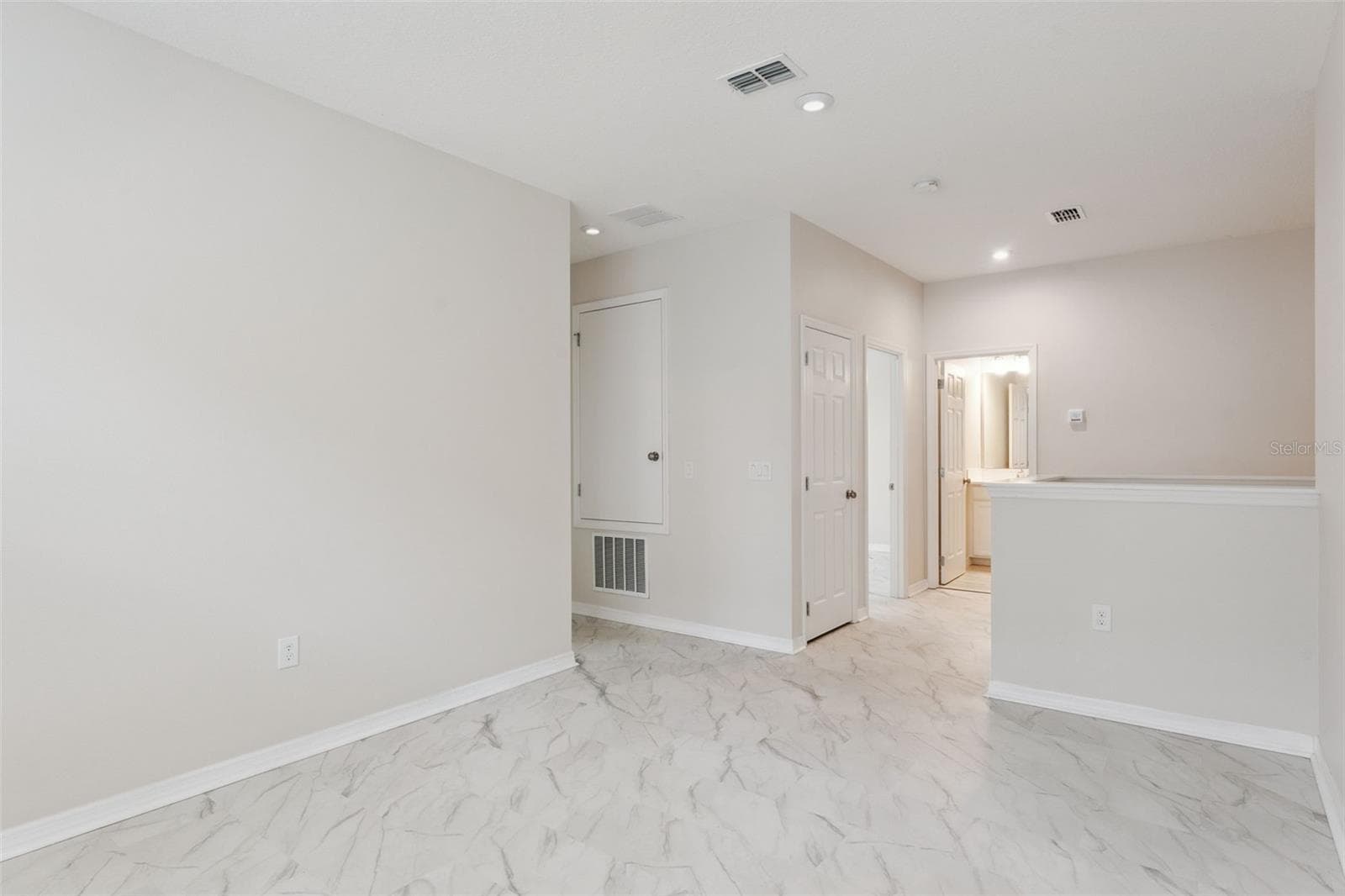 Upstairs Loft – Open upstairs loft provides additional flexible living space with marble-look tile flooring, recessed lighting, and convenient access to the surrounding bedrooms and bath. - 1287 VERDANT GLADE PL, WINTER PARK