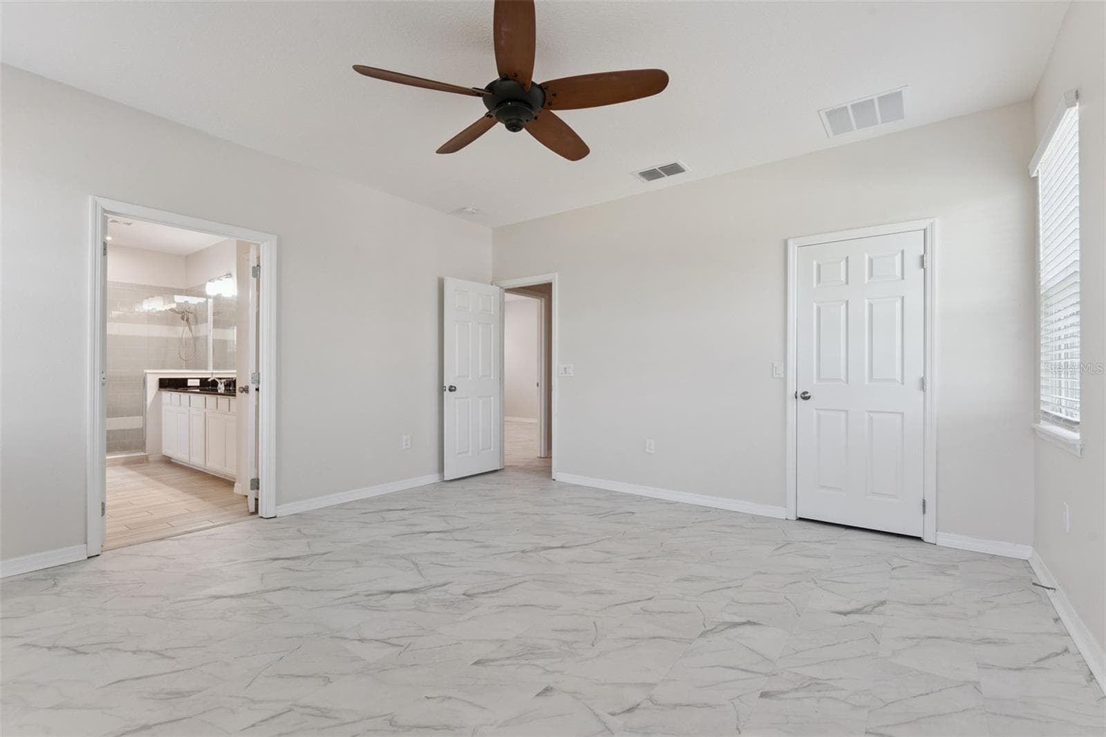 2nd Primary Suite (Upstairs)  – Another angle showcases the bedroom’s spacious layout and direct connection to the en-suite bath. - 1287 VERDANT GLADE PL, WINTER PARK